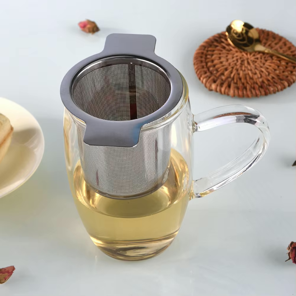 showing tea infuser with tea in glass
