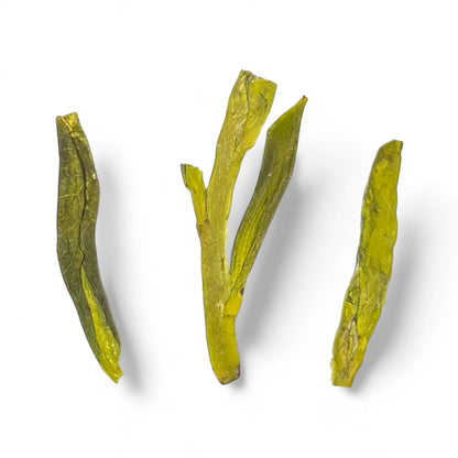 closeup of 3 leaves of dragonwell (long jing) tea