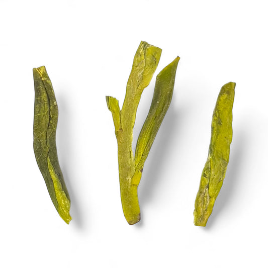 closeup of 3 leaves of dragonwell (long jing) tea