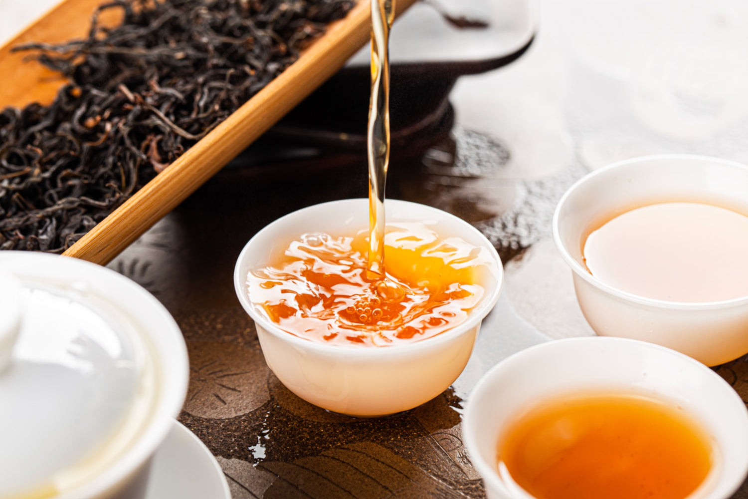 3 cups of yunnan black (dian hong) tea being served traditional style
